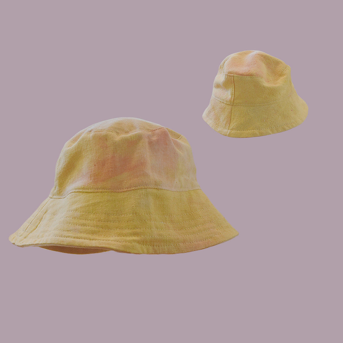 Two handsewn bucket hats floating on background